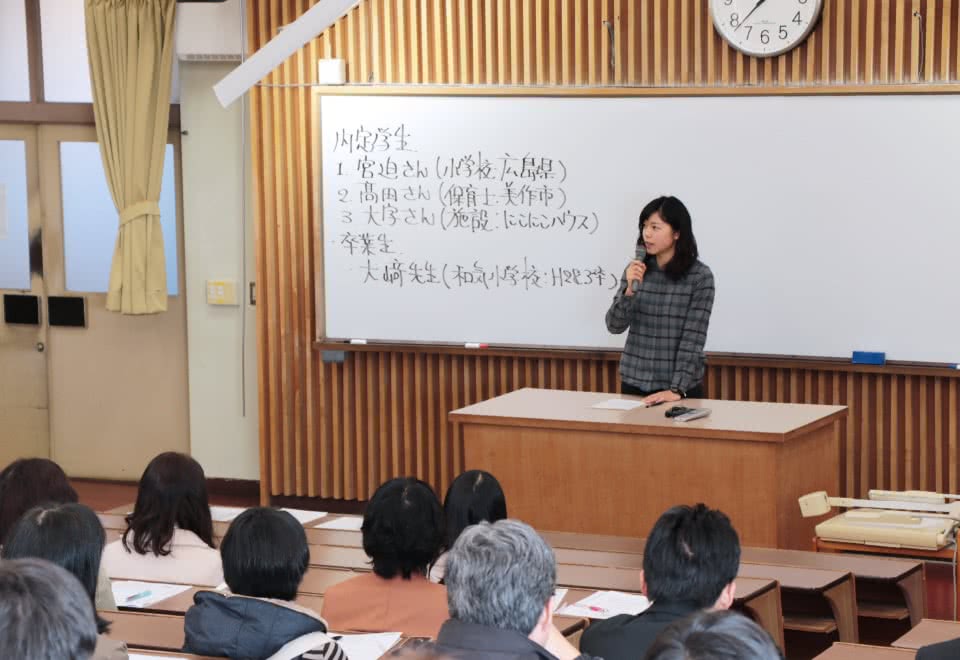 写真:就職活動体験談の壇上で語る女子卒業年次生と、それを聞く学生たち